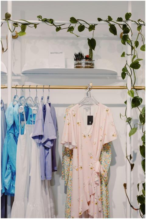 Elegant dresses hanging in a boutique store with a