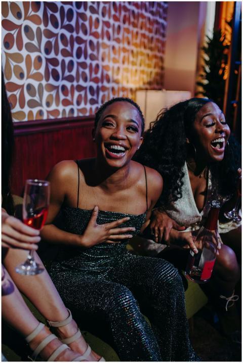 Joyful moment among friends enjoying drinks and la