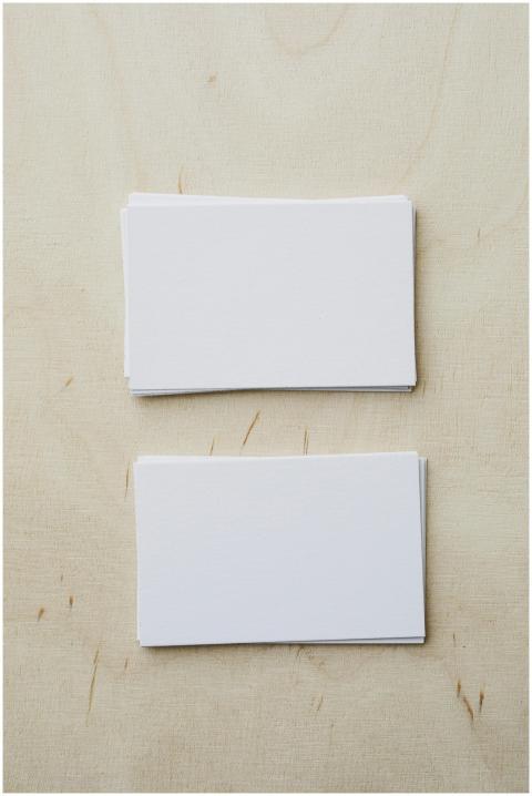 Top view of stacks of white mockup greeting cards