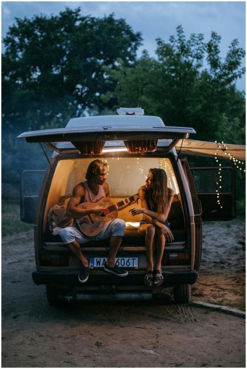 Two adults enjoying a musical road trip evening in