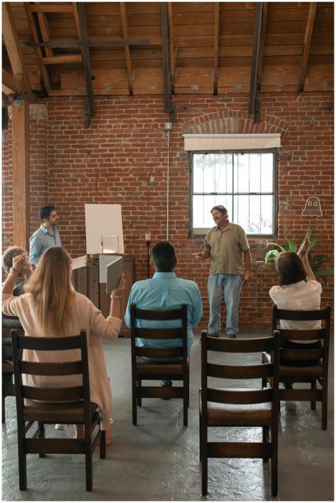 Adults attending a class in a rustic brick-walled