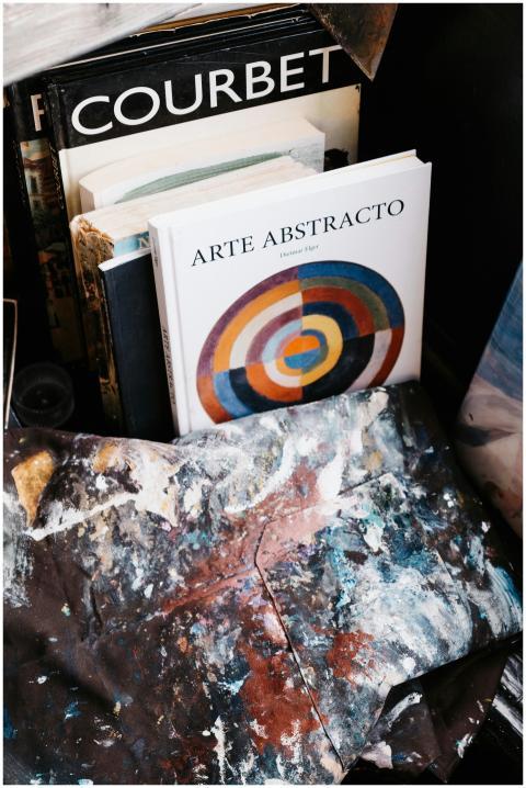 A display of abstract art books with paint-splatte
