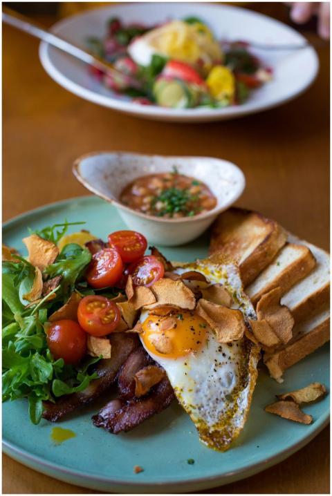 A vibrant breakfast plate featuring bacon, sunny s