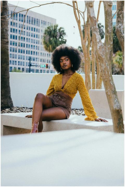 Fashionable woman with afro hairstyle posing on a