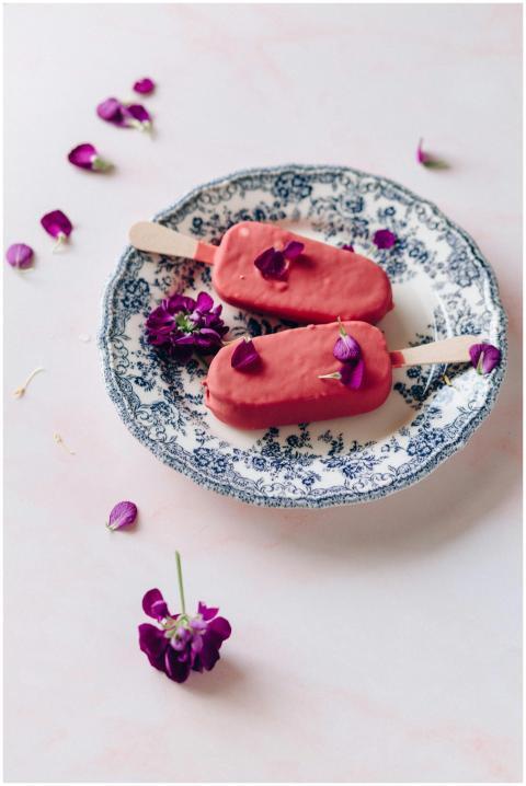 Delicate pink popsicles adorned with flower petals