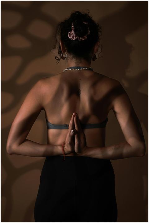 A woman practicing yoga in a serene pose, promotin