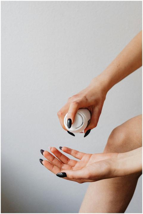 Close-up of a woman's hands with black nail polish