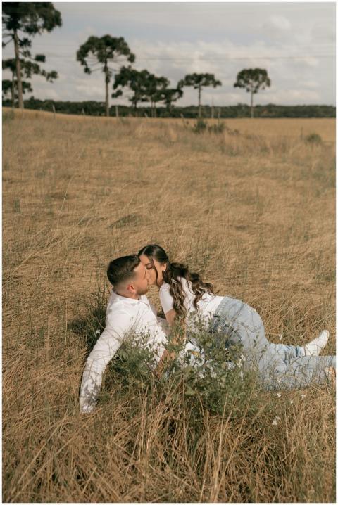 A loving couple shares a tender kiss in a sunny me