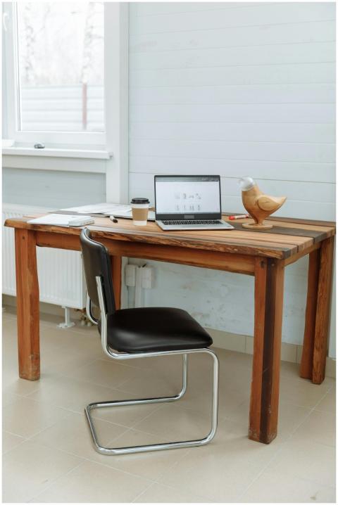 Simple office desk setup with a laptop, coffee cup