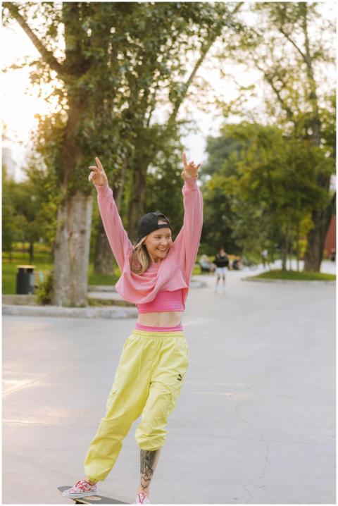 A young woman skateboarder exudes happiness while