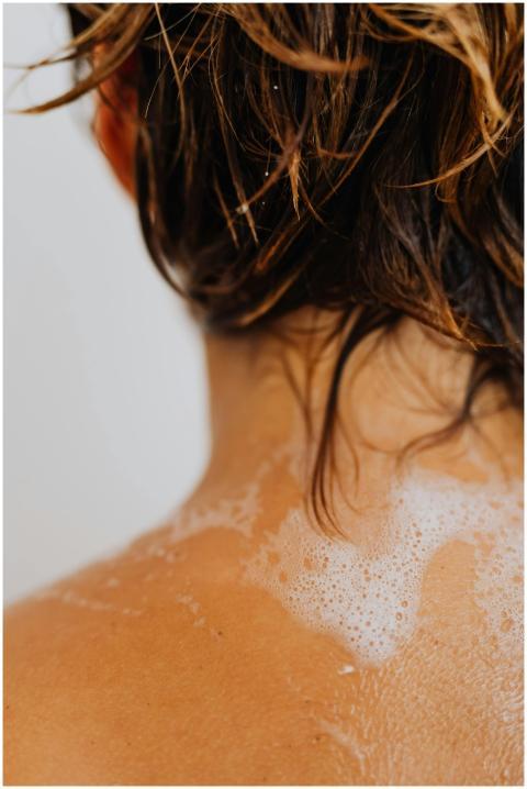 Detailed shot of wet hair with soapy water on a ba