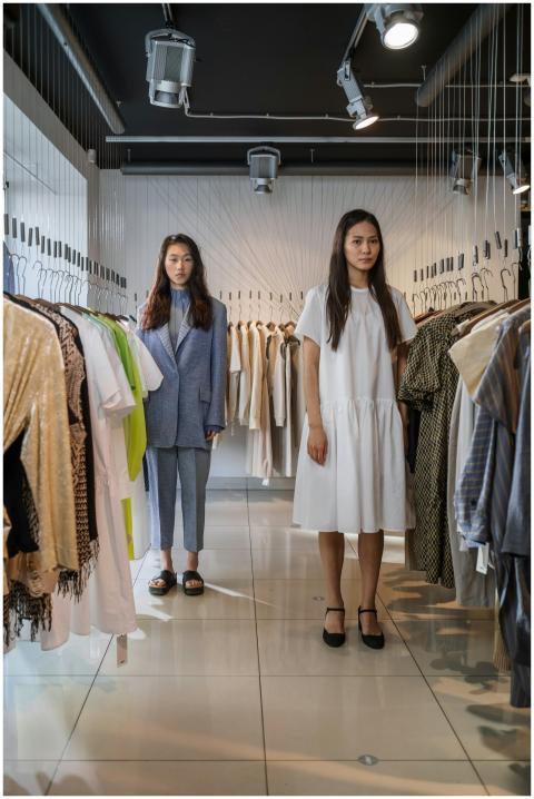 Two Asian women in a chic fashion boutique display