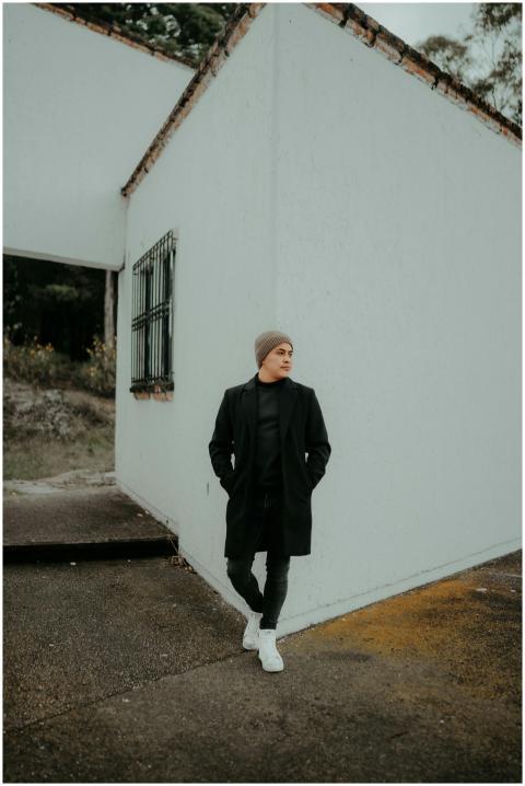 Man in modern outfit poses outdoors in San Cristób