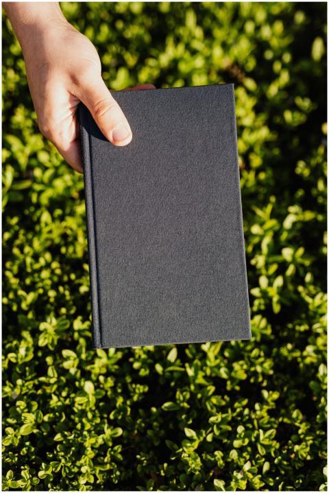 From above crop faceless student with black diary