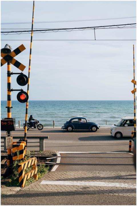 Coastal road scene in Kamakura, Japan with cars an