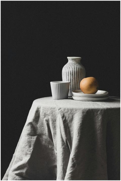 Minimalist still life featuring a pear and striped