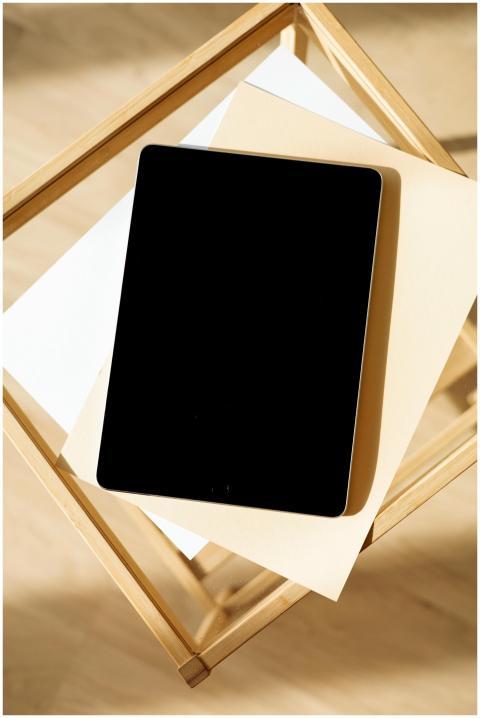 Minimalist setup of a tablet on a wooden table wit