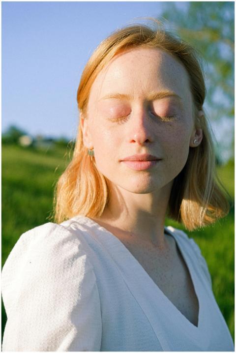 Tranquil portrait of a woman enjoying sunlight wit