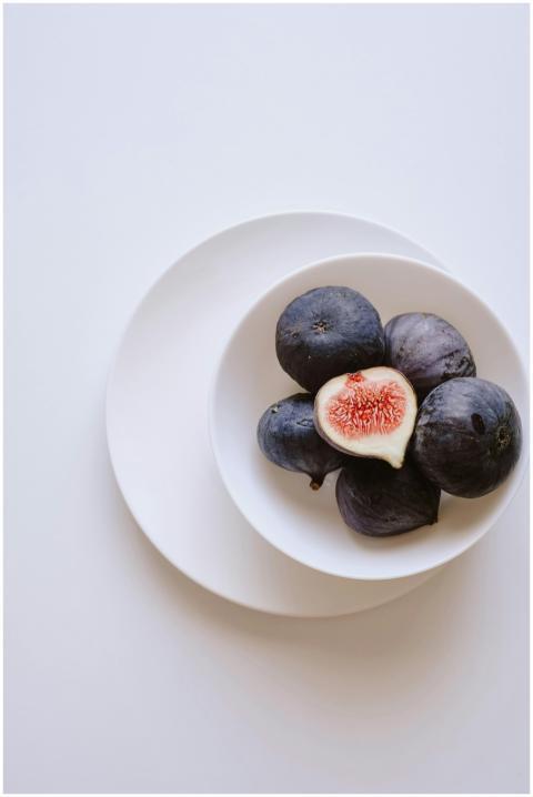 Elegant arrangement of fresh figs on a white plate