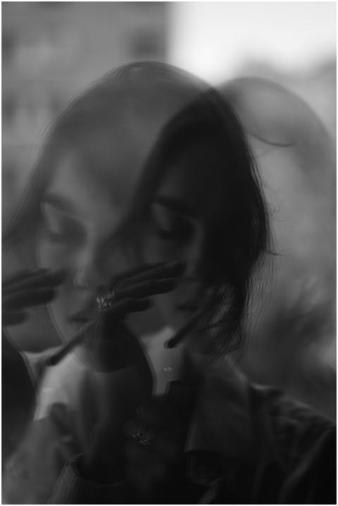 Black and white double exposure of a woman creatin