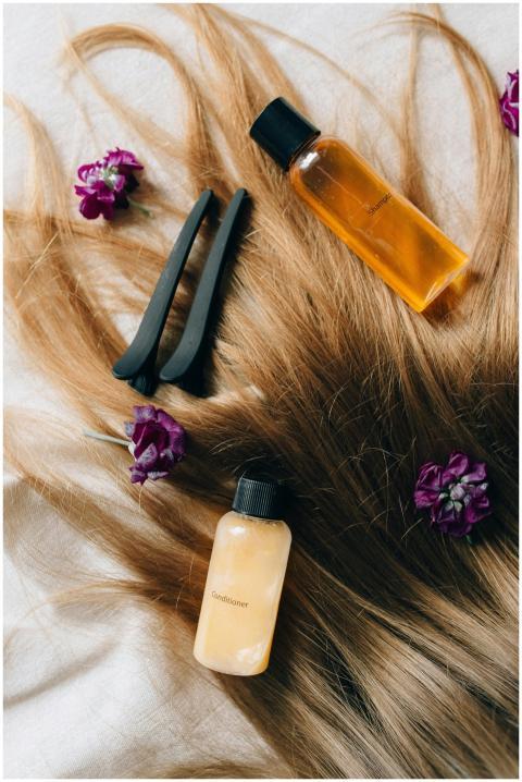 Aesthetic flatlay of hair care items and flowers a