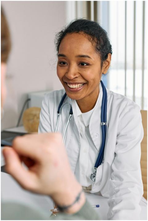 A smiling doctor in a white coat with a stethoscop