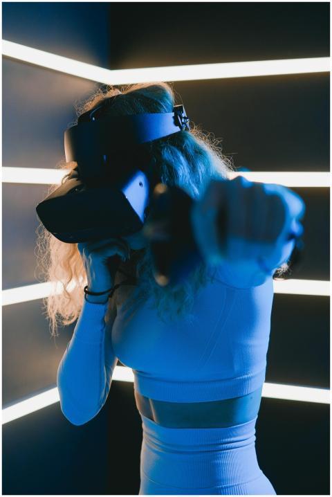 An adult woman using VR glasses, immersed in a vir