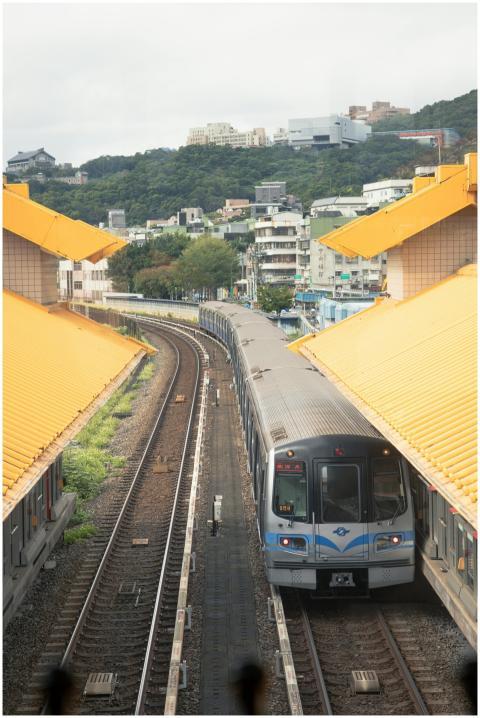 Aerial view of a train approaching the station wit