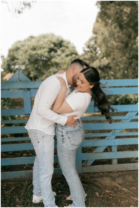 A young couple in casual clothes shares a loving e