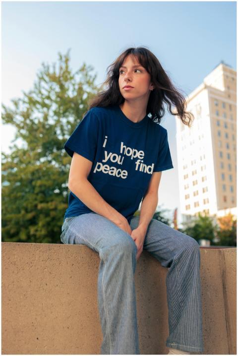 Portrait of young woman in jeans and t-shirt with