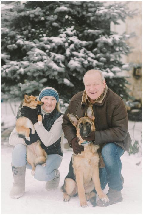 Senior couple with German Shepherd and another dog