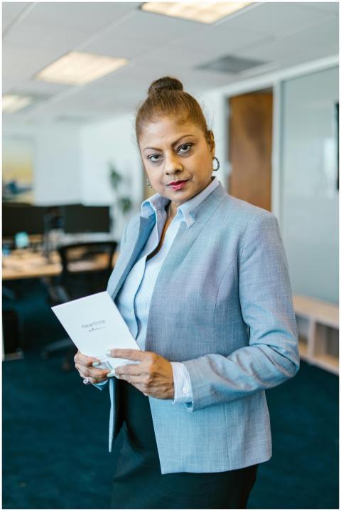 Confident businesswoman in office holding a docume