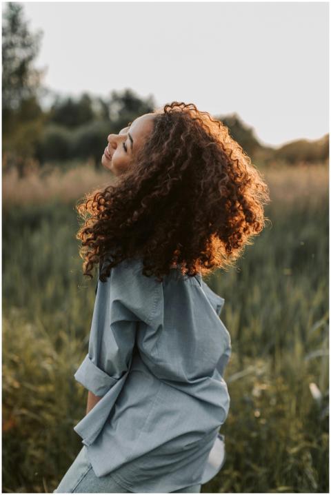 A carefree woman enjoying nature, showcasing happi