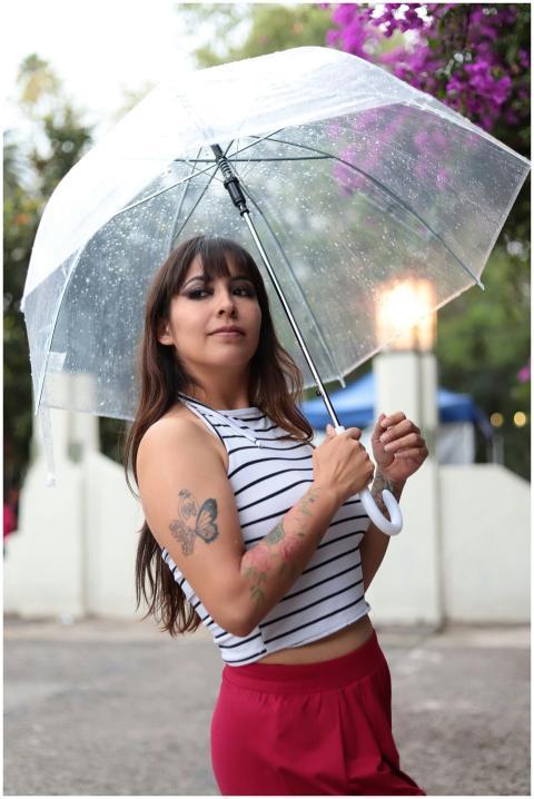 Vibrant outdoor portrait of a young woman holding