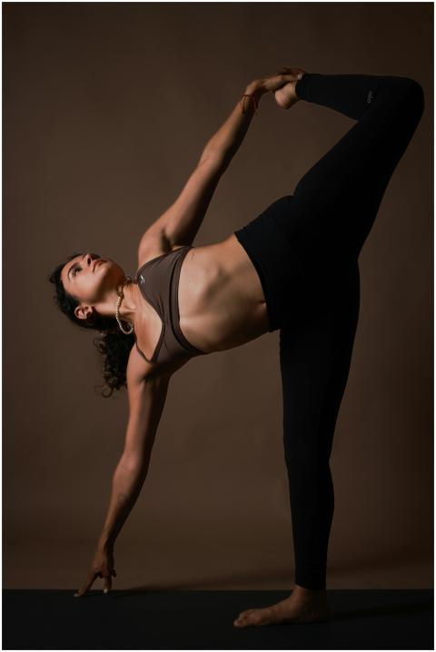 Woman practicing a graceful yoga pose with concent