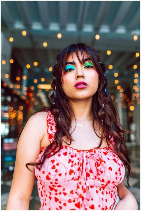 Stylish woman with colorful makeup and heart-patte