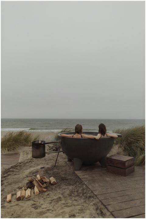 Two women enjoying a peaceful hot tub by the sea,