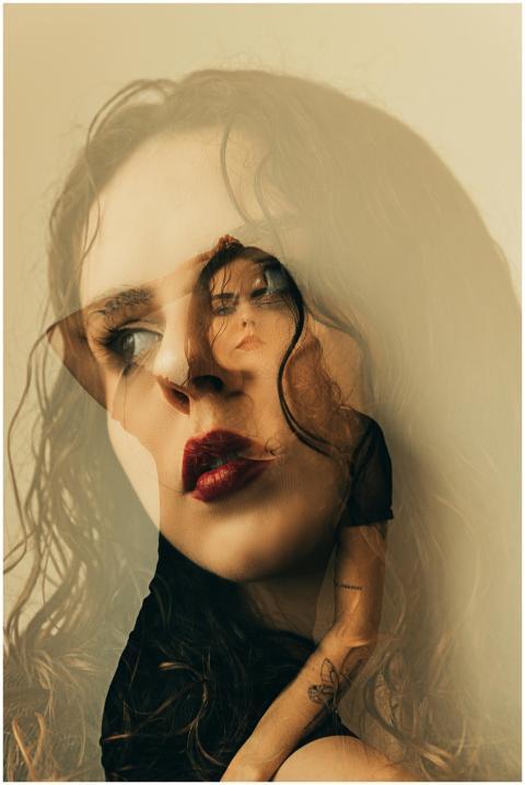Artistic double exposure portrait featuring a woma