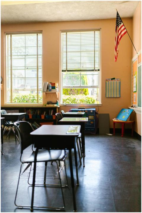 A peaceful classroom with empty desks, American fl