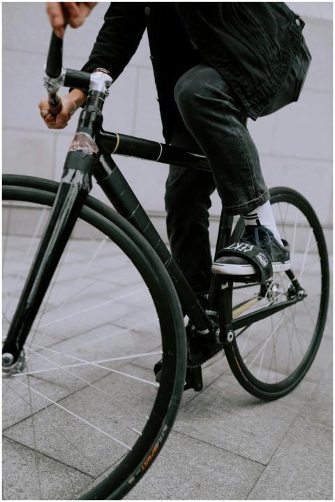 Close-up of a cyclist riding a black fixed gear bi