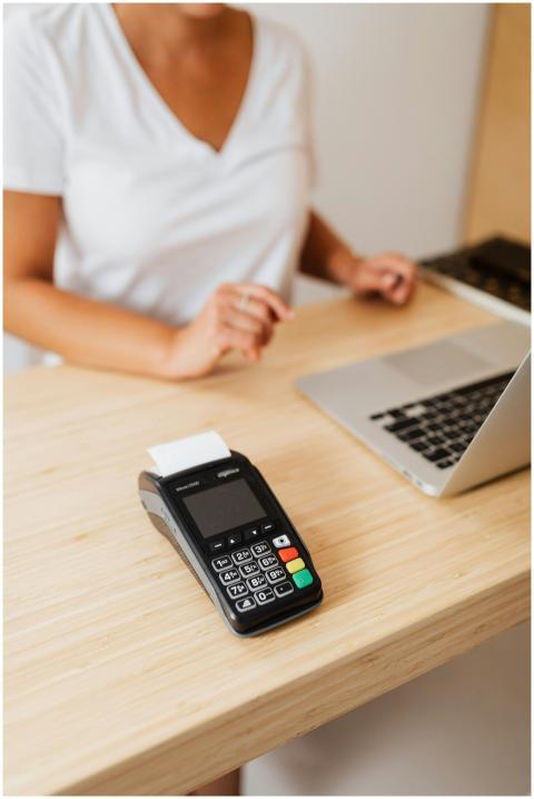 A cashier processes a cashless transaction using a
