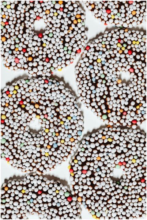 Top view of colorful chocolate-covered donuts with