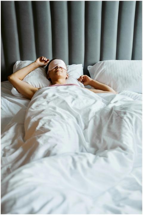 Relaxed woman wearing eye mask, comfortably sleepi