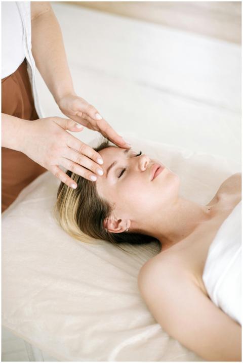 A woman enjoys a relaxing face massage at a spa, p
