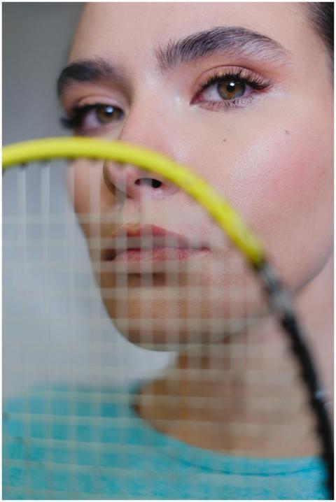 A detailed portrait of a woman holding a badminton