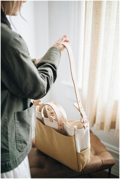A modern canvas and leather tote bag is highlighte