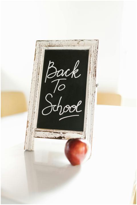 A chalkboard with 'Back to School' text and a red