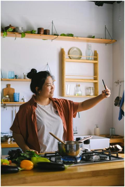 Asian woman taking a selfie while cooking and prep