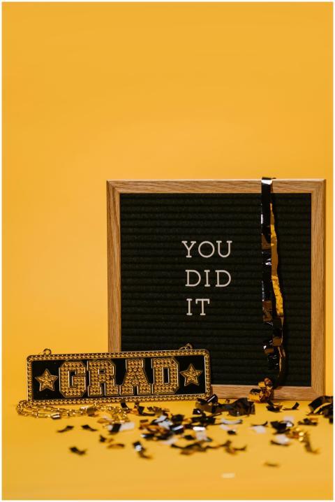 Graduation celebration with board sign saying 'You