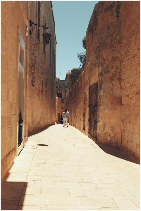 A sunlit narrow alley in the historic city of Mdin
